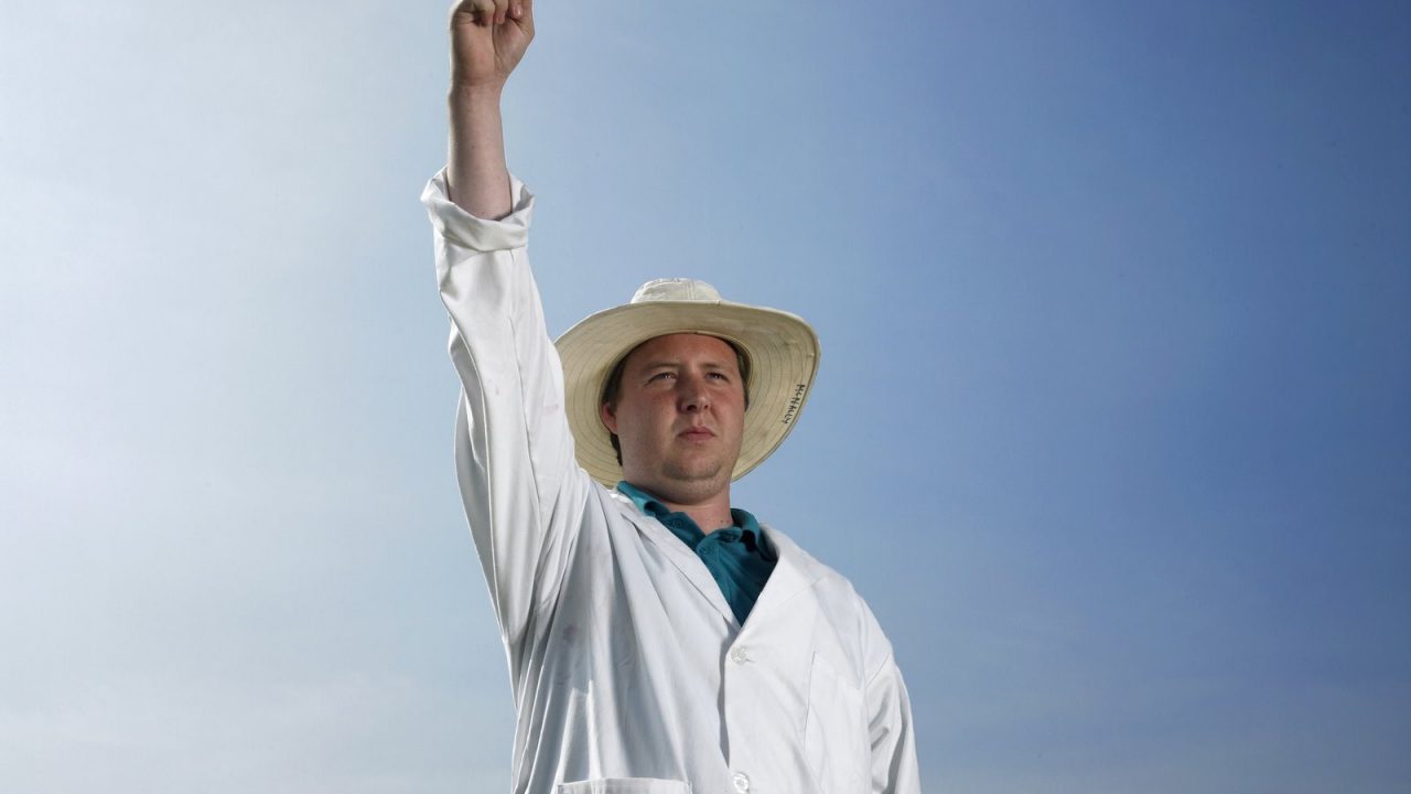 Cricket umpire raising a finger to give a batter out