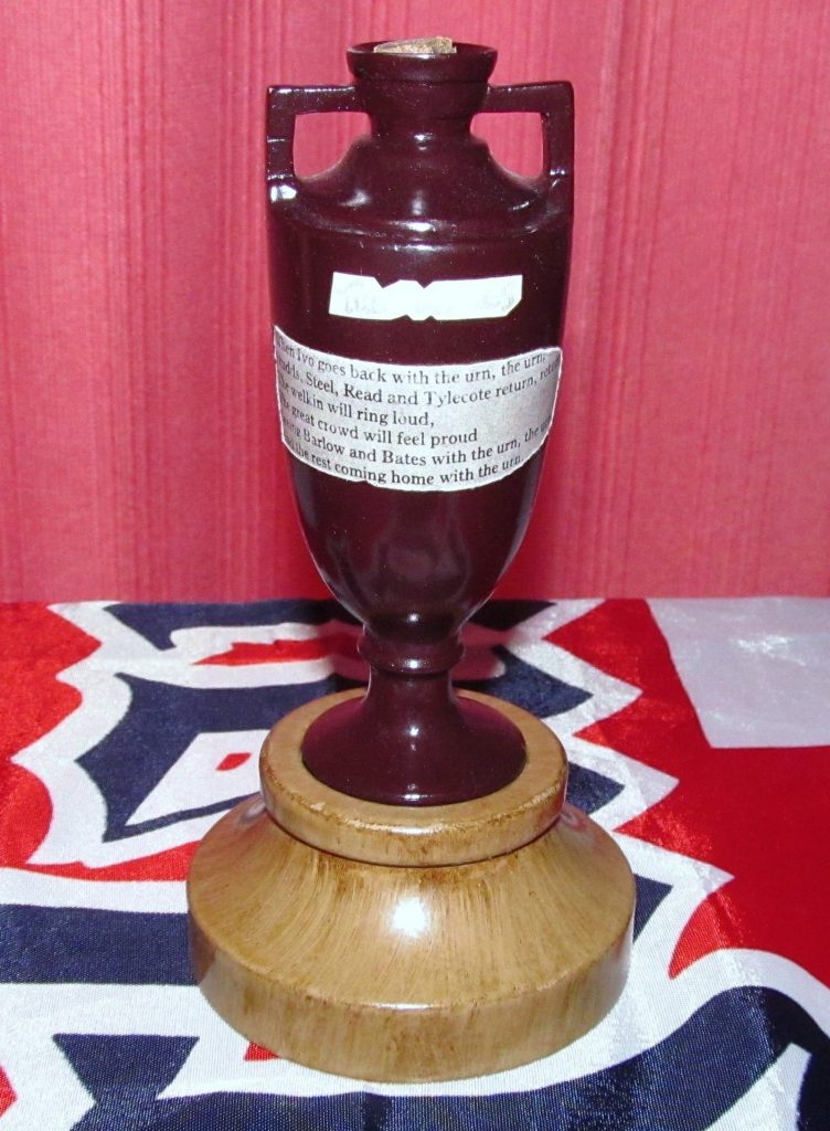 The small terracotta Ashes urn in a display case